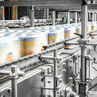 A manufacturing line where aluminum cans are whirling past.