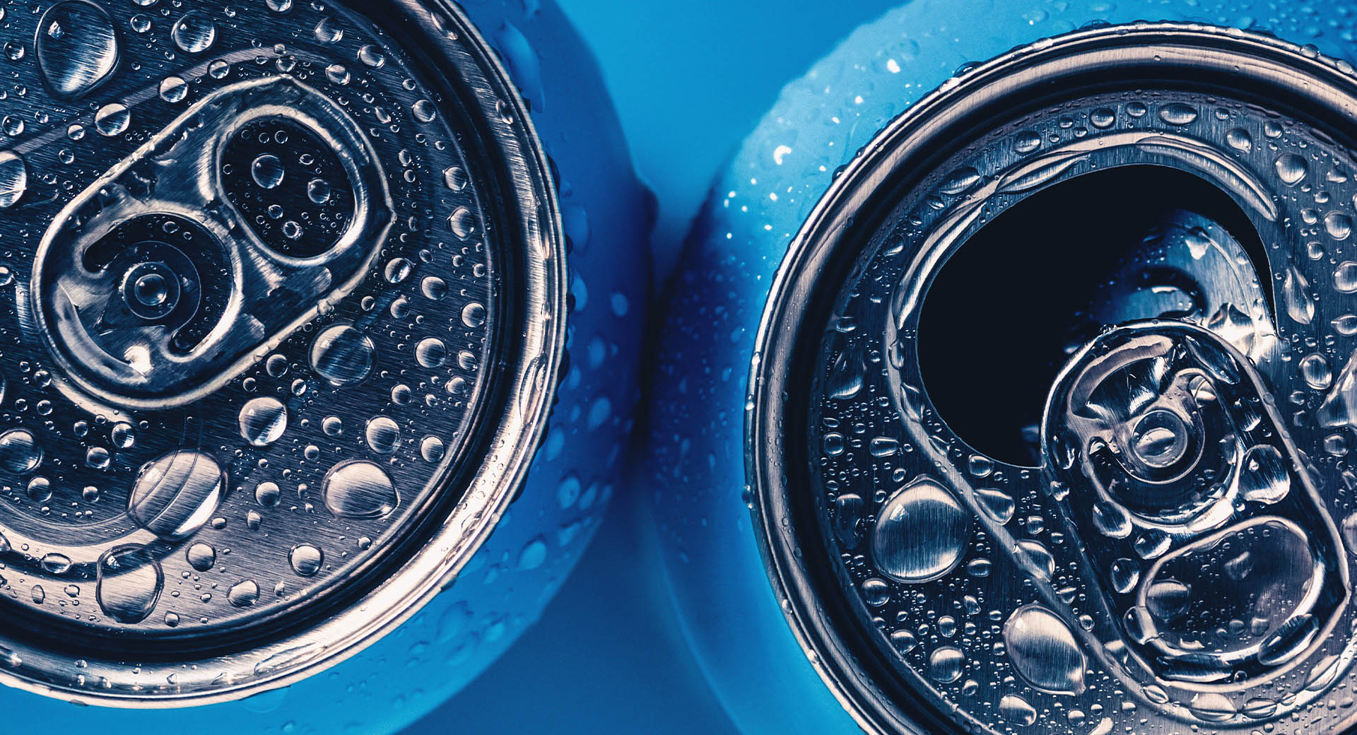 Blue aluminum cans with water drops on them.